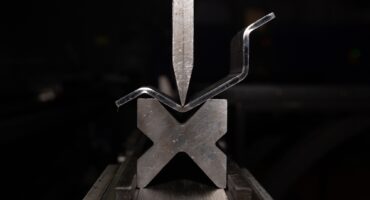 working with sheet metal on CNC hydraulic press brake. Bending sheet metal